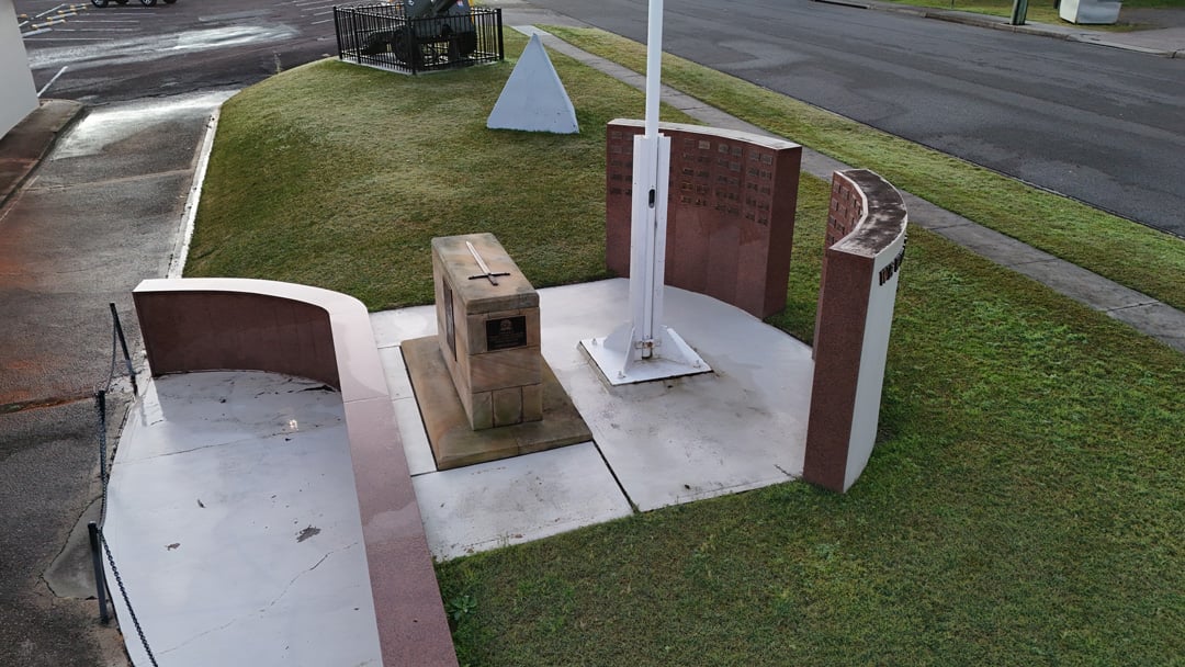 War memorial with stone plaques and flagpole at Wangi RSL grounds